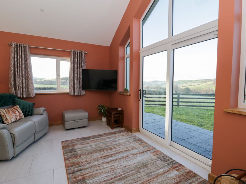 A living room with a sofa and television at Y Stabal near Llanilar