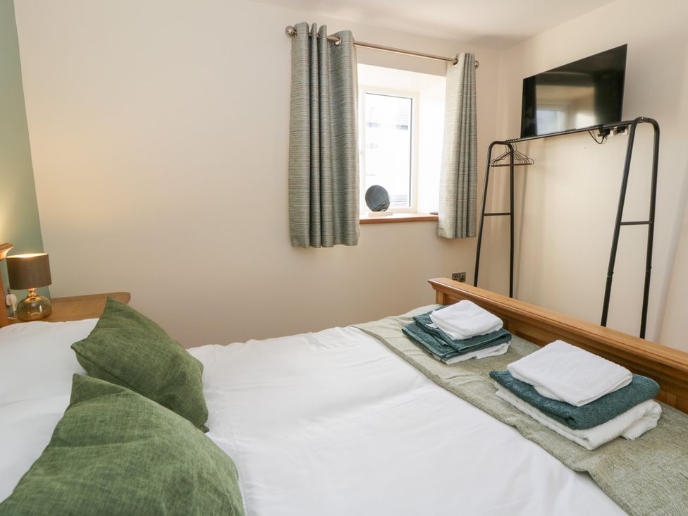 A bedroom with a bed and window at Y Stabal near Llanilar