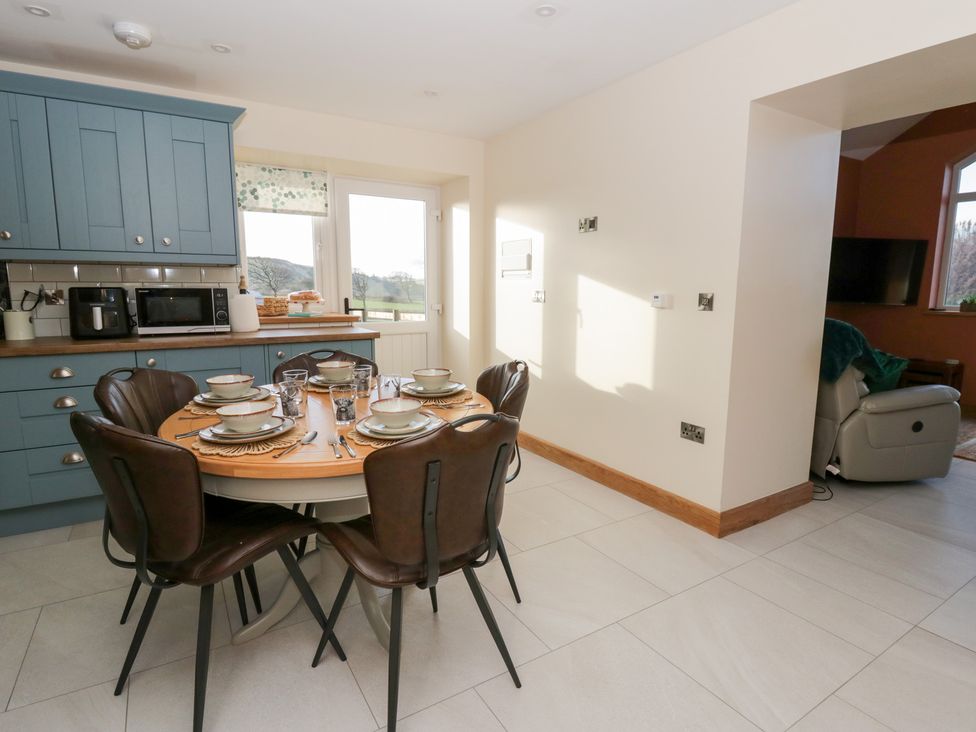 A dining area with a table set for meals at Y Stabal near Llanilar