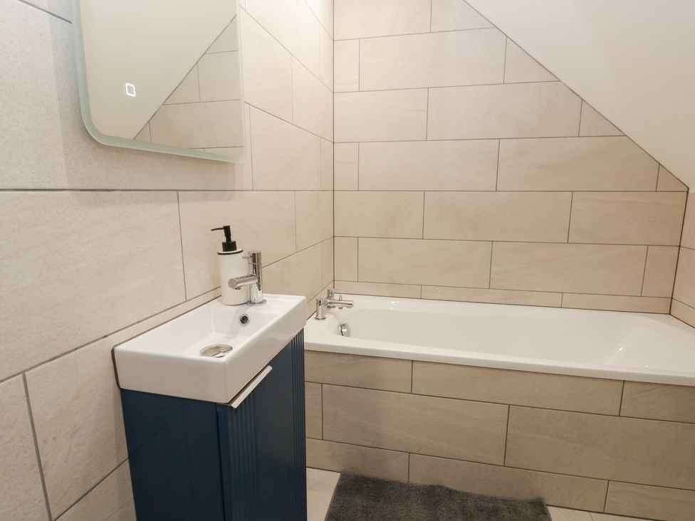 A bathroom with a sink and bathtub at Y Stabal near Llanilar
