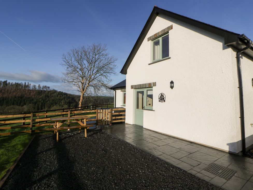 A house with a patio and fencing at Y Stabal near Llanilar