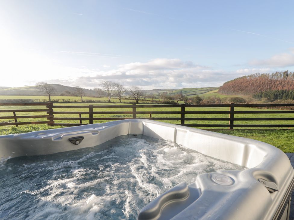 A hot tub with water and a view of fields at Y Stabal near Llanilar