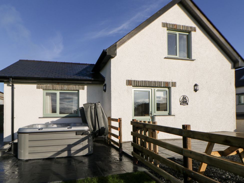 An outdoor area with a hot tub and fence at Y Stabal near Llanilar