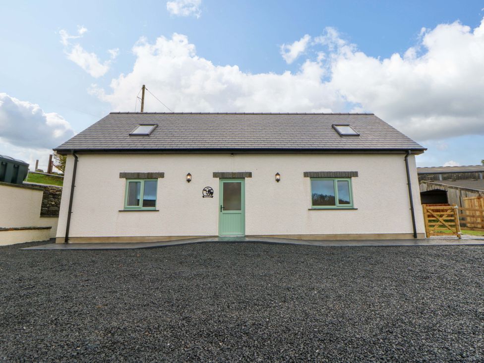 A house with a green door and windows at Y Beudy near Llanilar