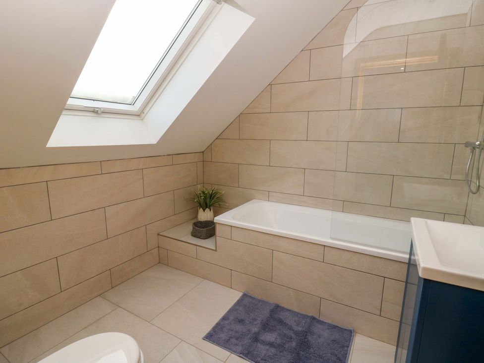 A bathroom with a bathtub and a shower at Y Beudy near Llanilar
