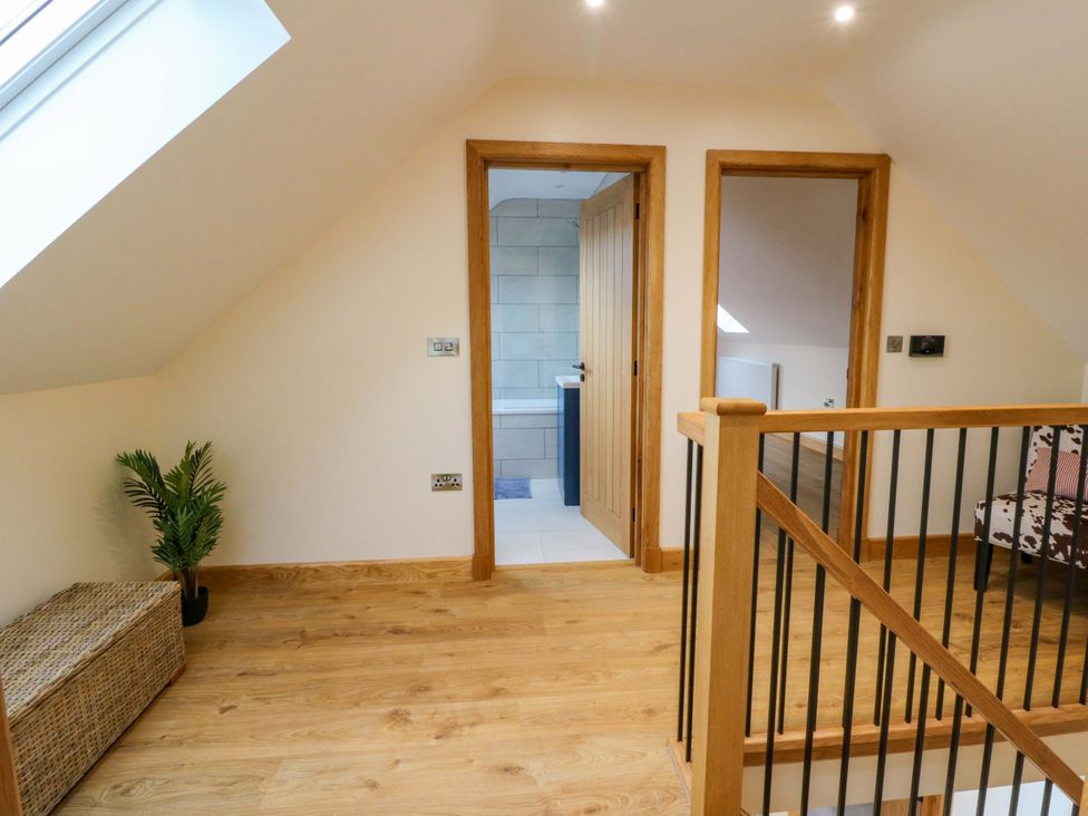A landing area with doors and a plant at Y Beudy near Llanilar
