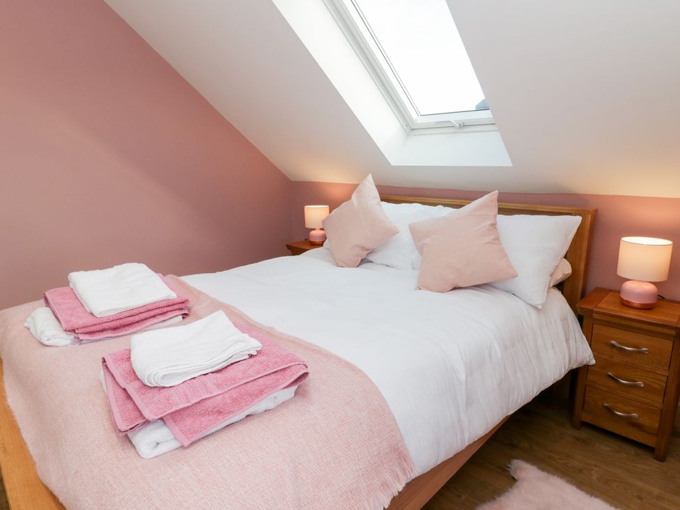 A bedroom with a bed and bedside tables at Beudy near Llanilar