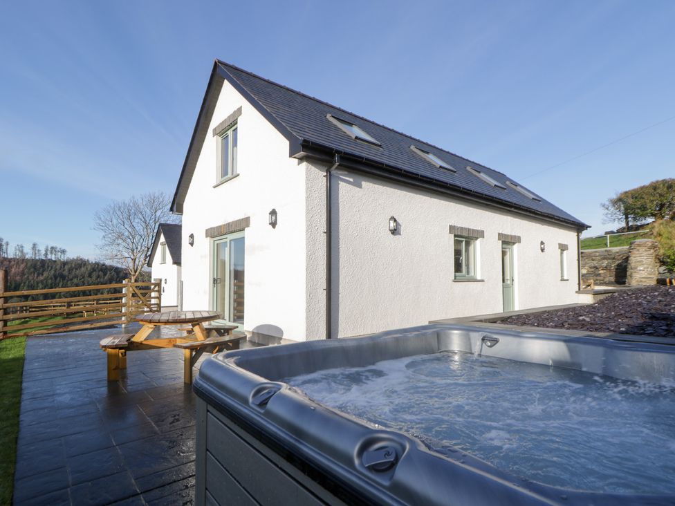 An outdoor space featuring a hot tub and seating at Beudy near Llanilar