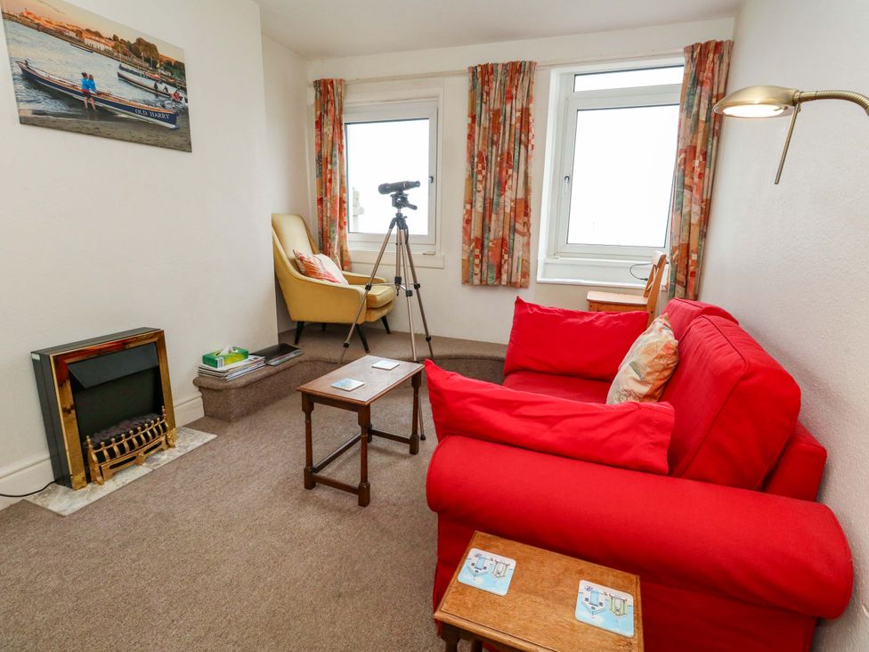 A living room with a sofa and chairs at Bay View in Swanage
