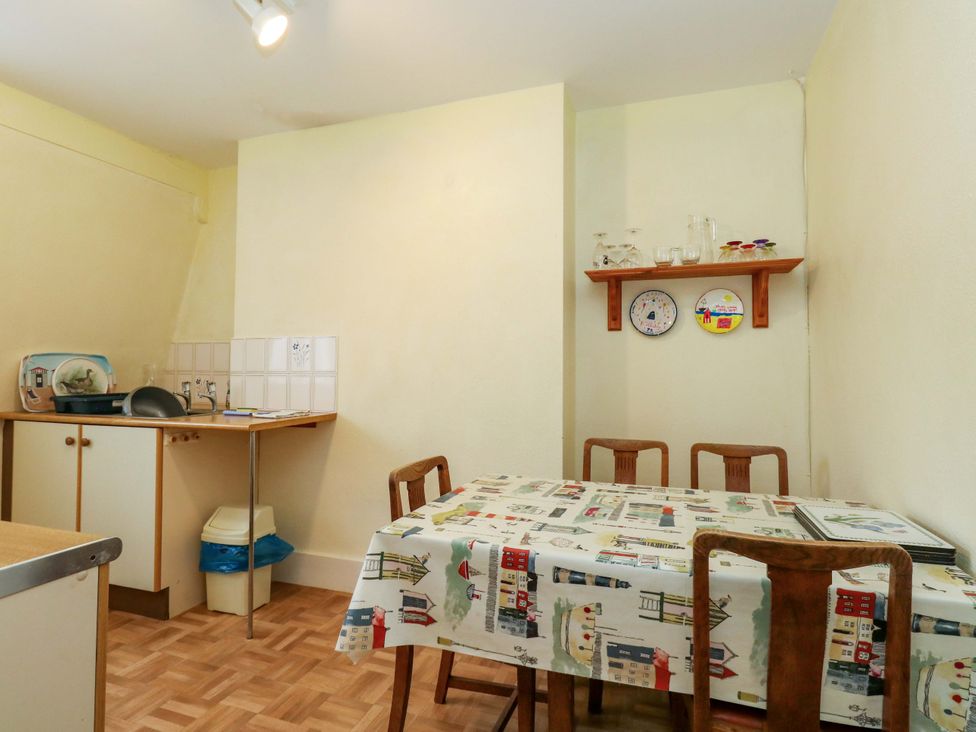 A kitchen with a table and chairs at Bay View in Swanage