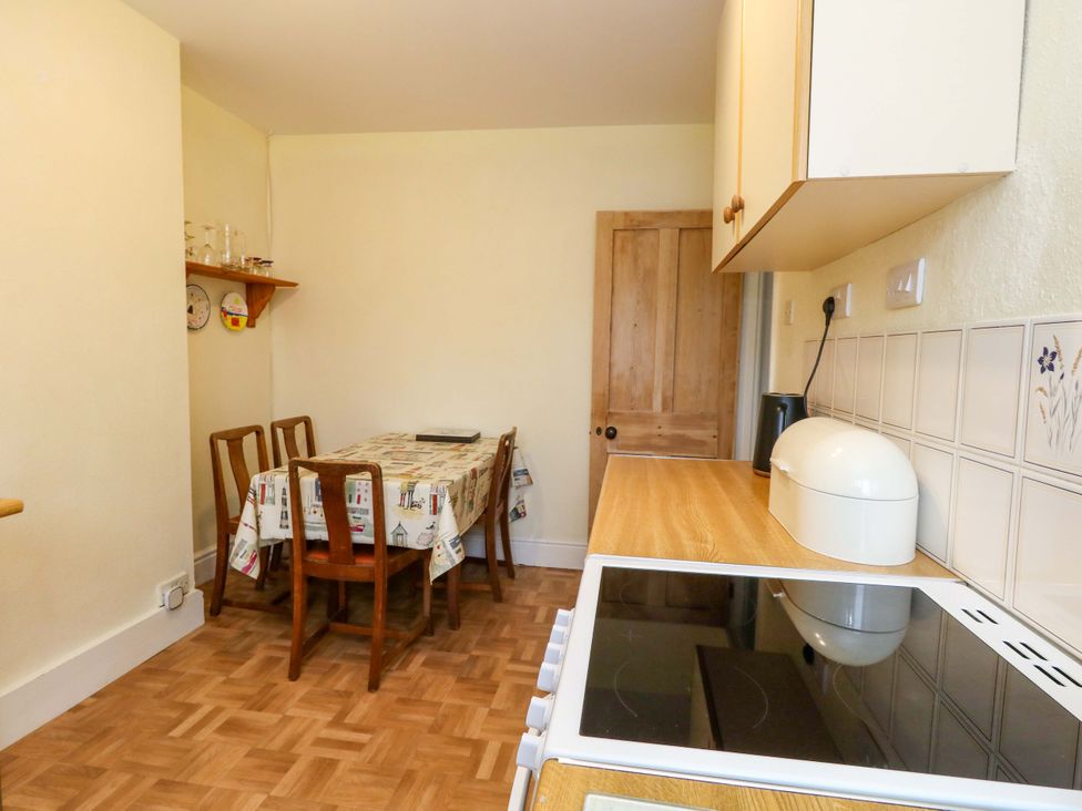 A kitchen with a table and chairs at Bay View in Swanage