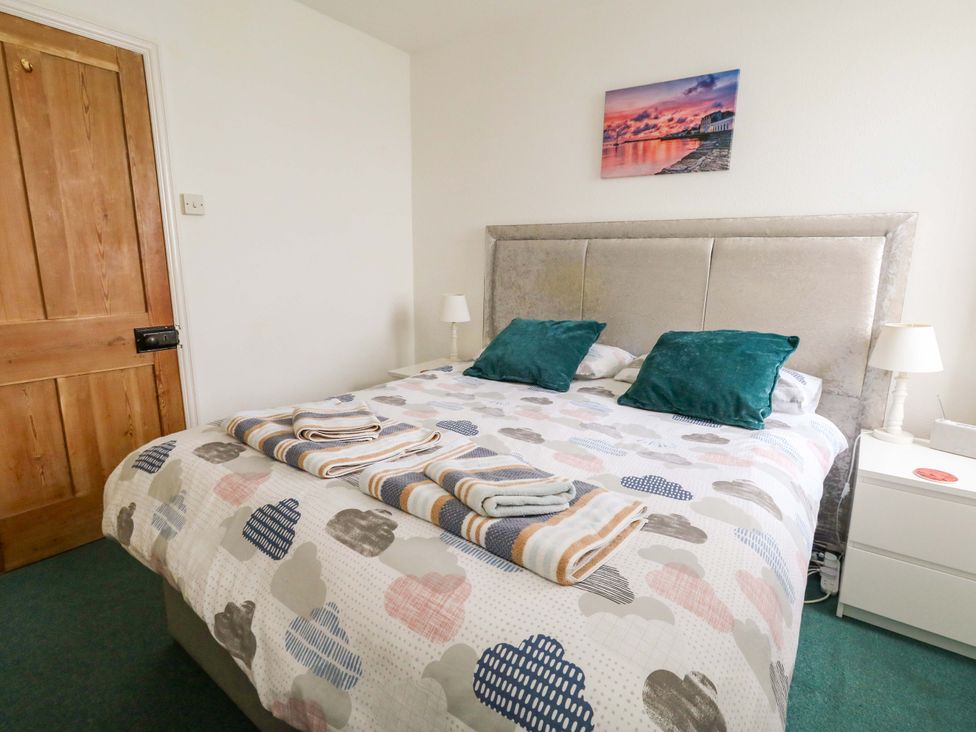 A bedroom with a bed and bedside table at Bay View in Swanage