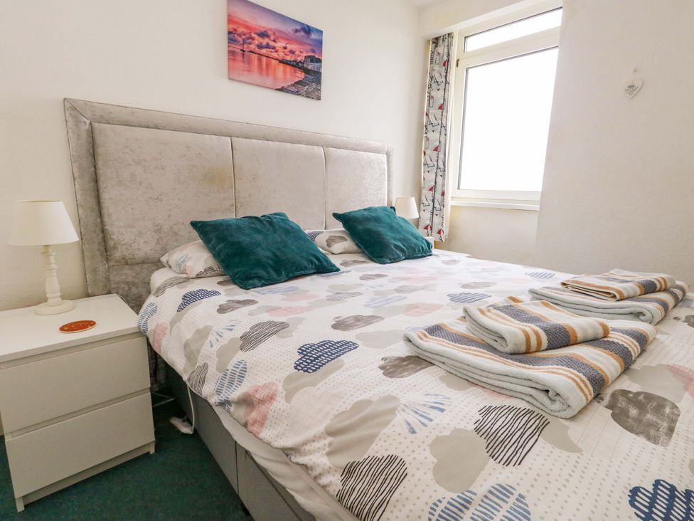A bedroom with a bed and nightstand at Bay View in Swanage