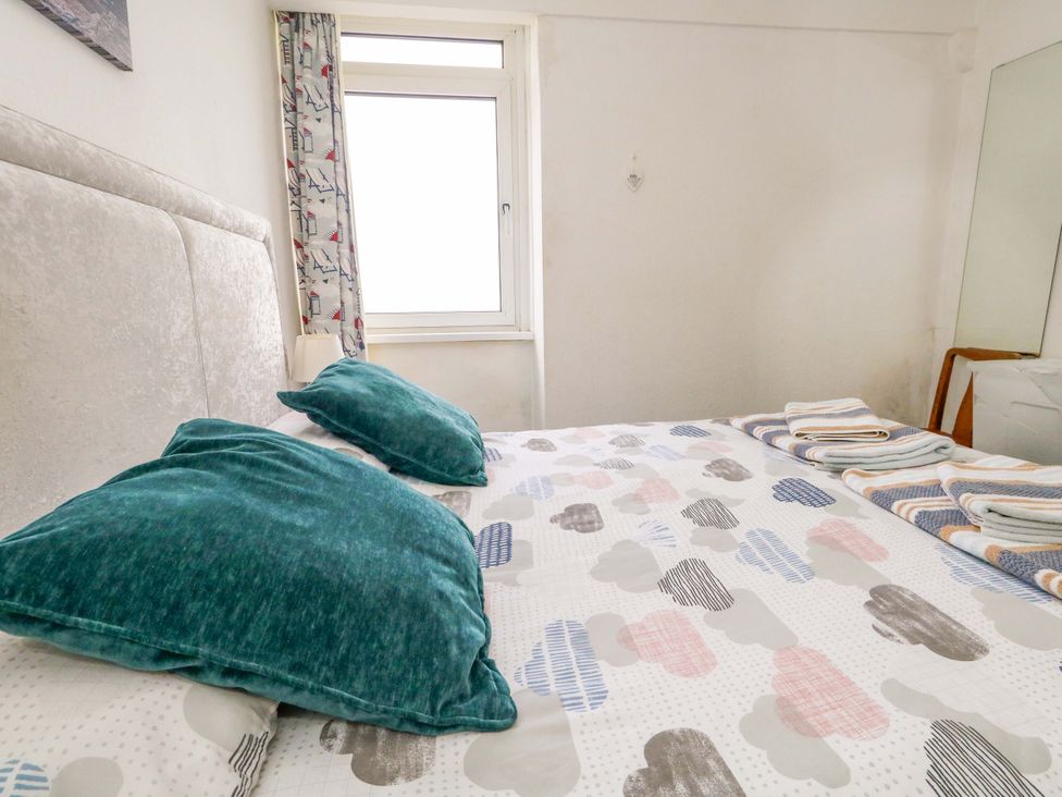 A bedroom with a bed and pillows at Bay View in Swanage