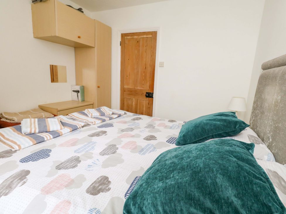 A bedroom with a bed and wardrobe at Bay View in Swanage