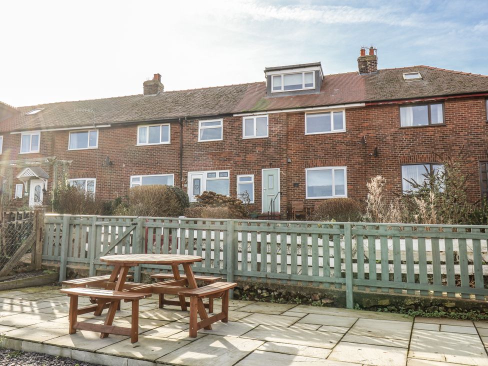 A house with a fence and garden furniture at Whitby View in Whitby