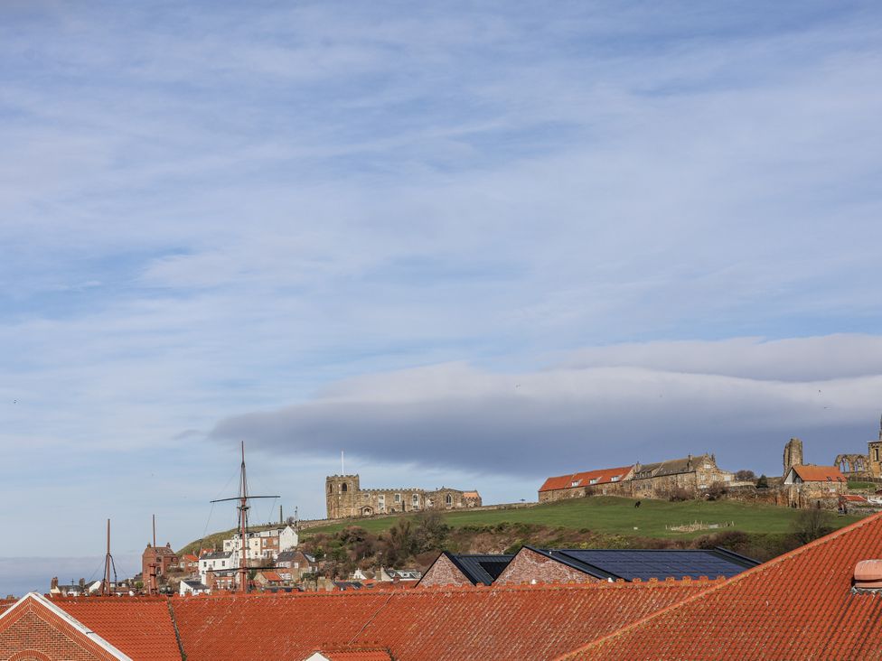 A view of rooftops and hilltop castle at Whitby View in Whitby