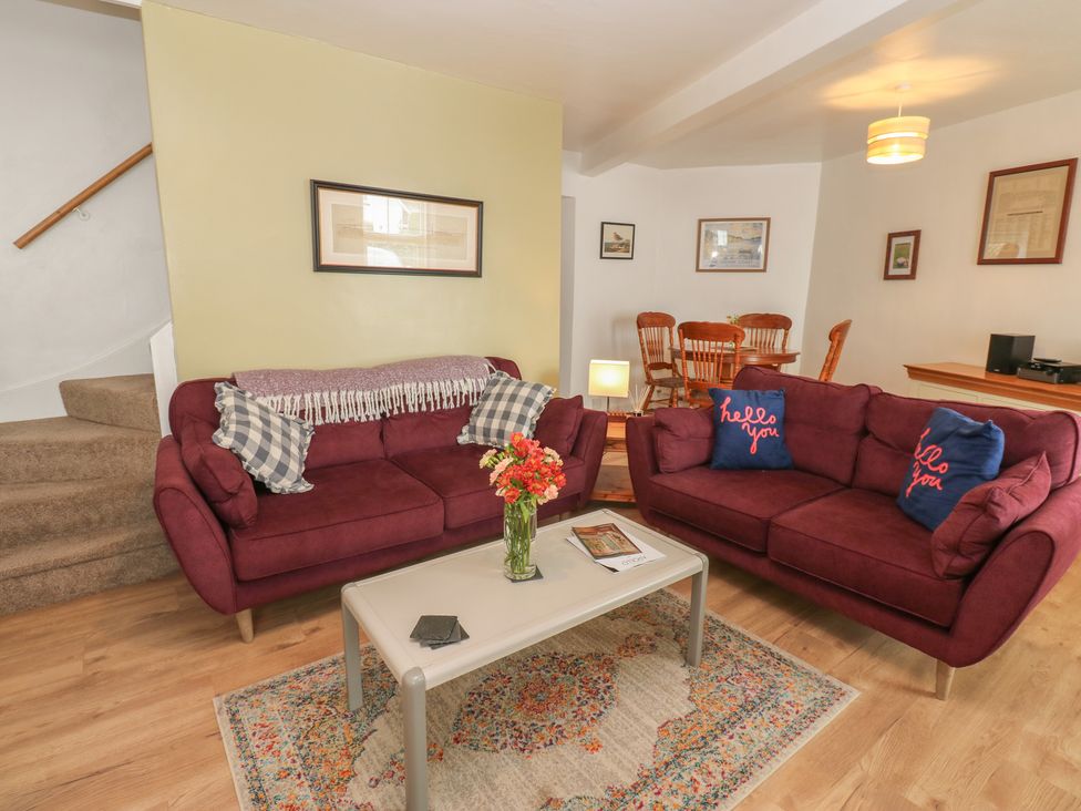 A living room with sofas and a dining area at 1 Eden Cottages Corby Hill