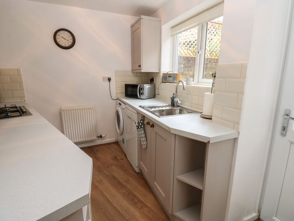 A kitchen with appliances and a window at 1 Eden Cottages in Corby Hill