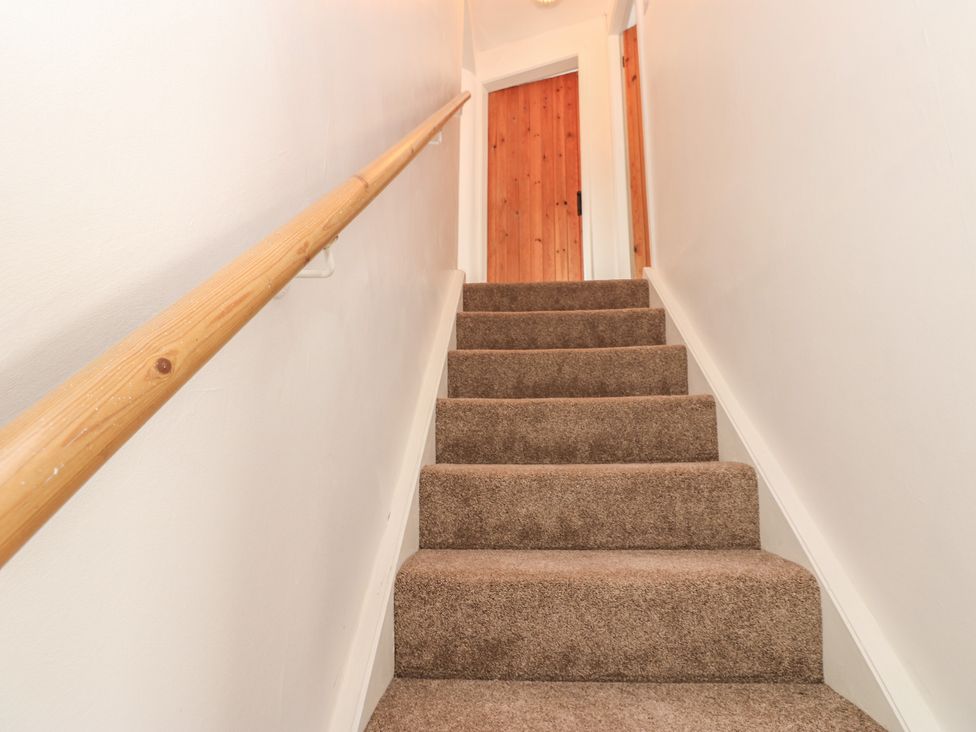 A staircase leading to a door at 1 Eden Cottages in Corby Hill