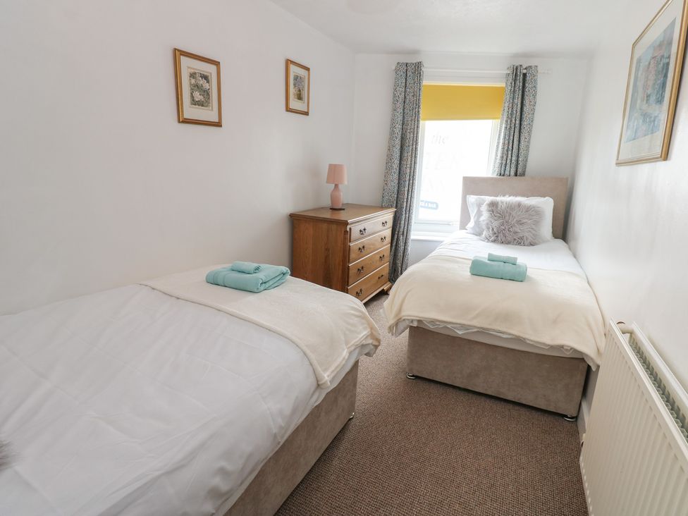 A bedroom with two single beds and a dresser at 1 Eden Cottages in Corby Hill