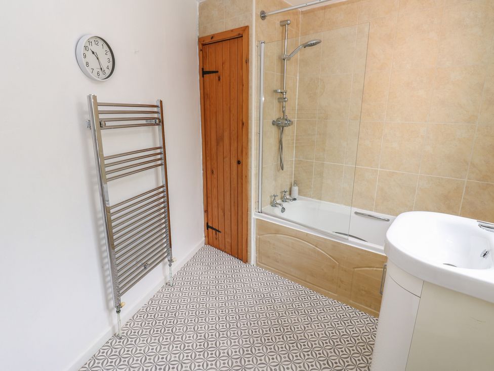 A bathroom with a bathtub and shower at 1 Eden Cottages in Corby Hill