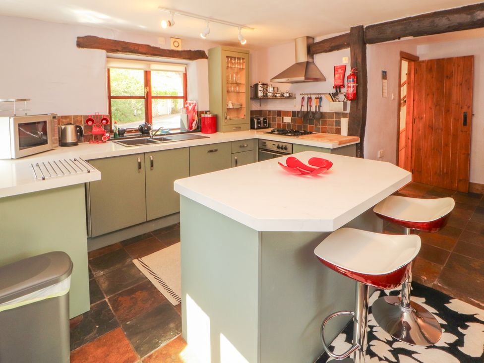 A kitchen with appliances and seating at Beck Edge in Braithwaite