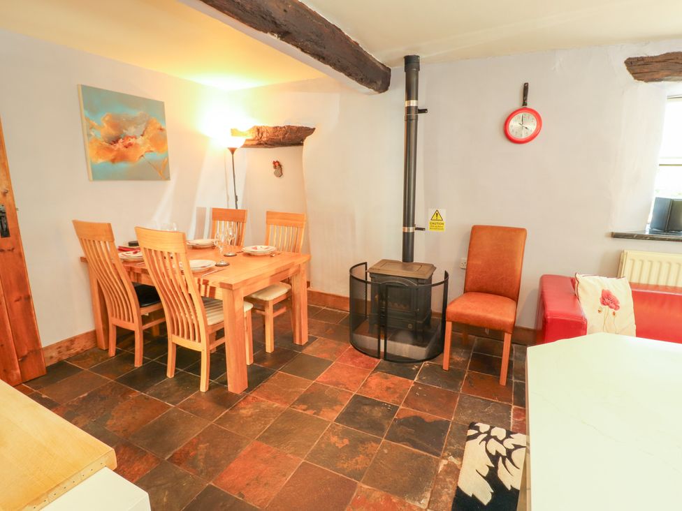 A dining room with a table and chairs at Beck Edge in Braithwaite