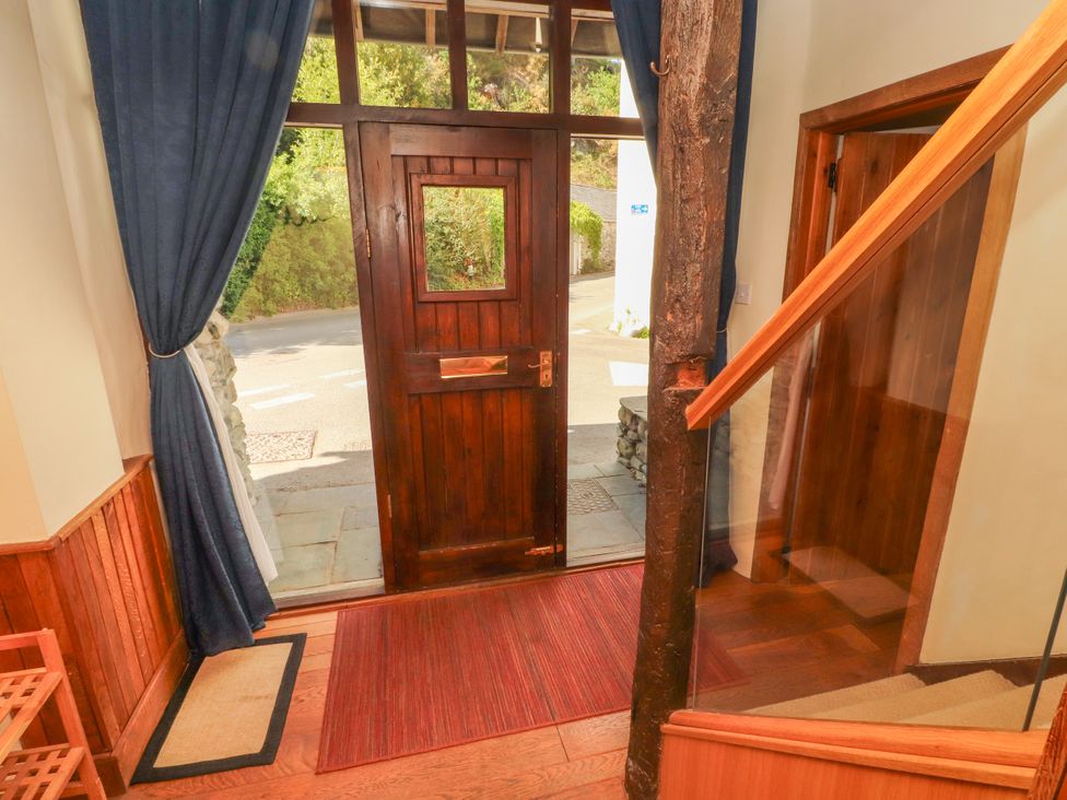 An entrance area with a door and staircase at Beck Edge in Braithwaite