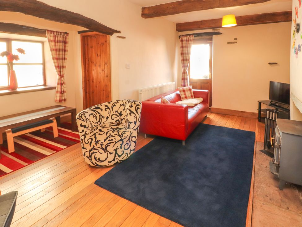 A living room with a sofa and armchair at Beck Edge in Braithwaite