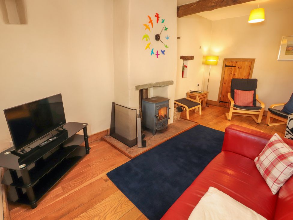A living room with a television and fireplace at Beck Edge in Braithwaite