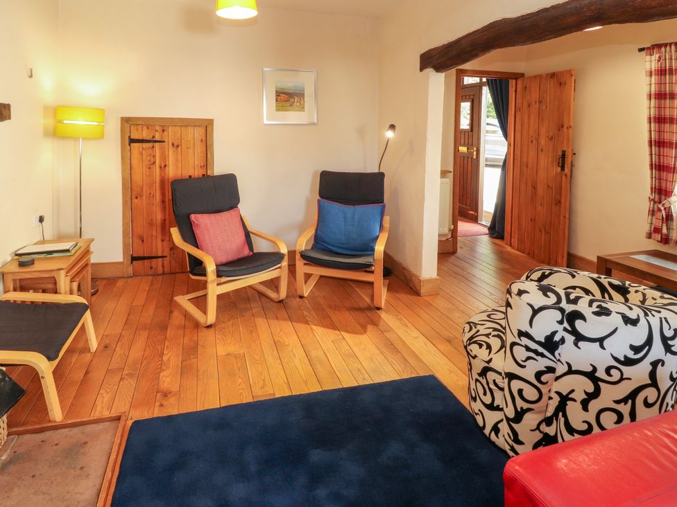 A living room with armchairs and a lamp at Beck Edge in Braithwaite