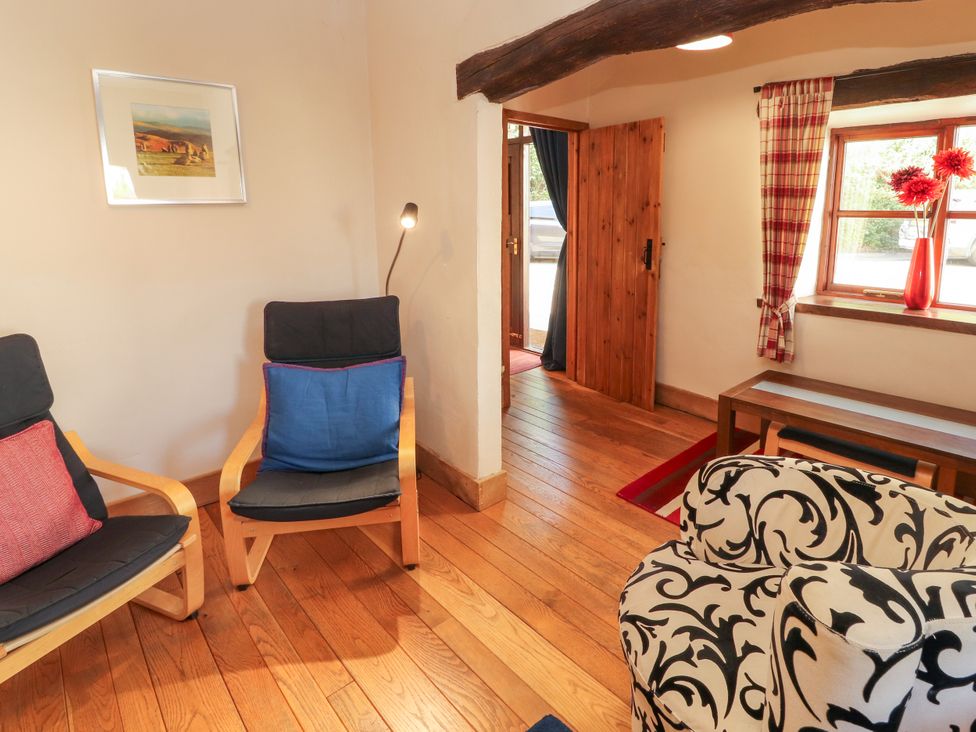 A living room with chairs and a table at Beck Edge in Braithwaite
