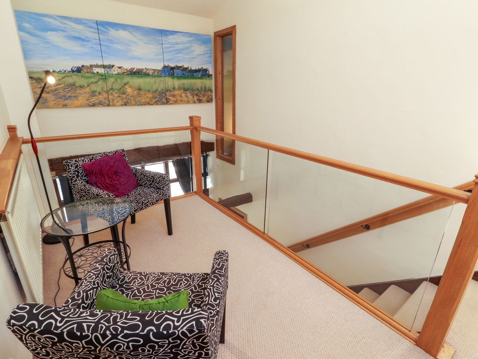 A landing with chairs, a table and wall art at Beck Edge in Braithwaite