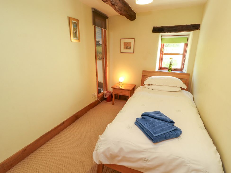 A bedroom with a bed and a nightstand at Beck Edge in Braithwaite