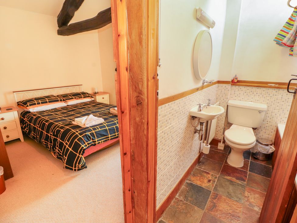 A bedroom with a bed and an adjoining bathroom at Beck Edge in Braithwaite