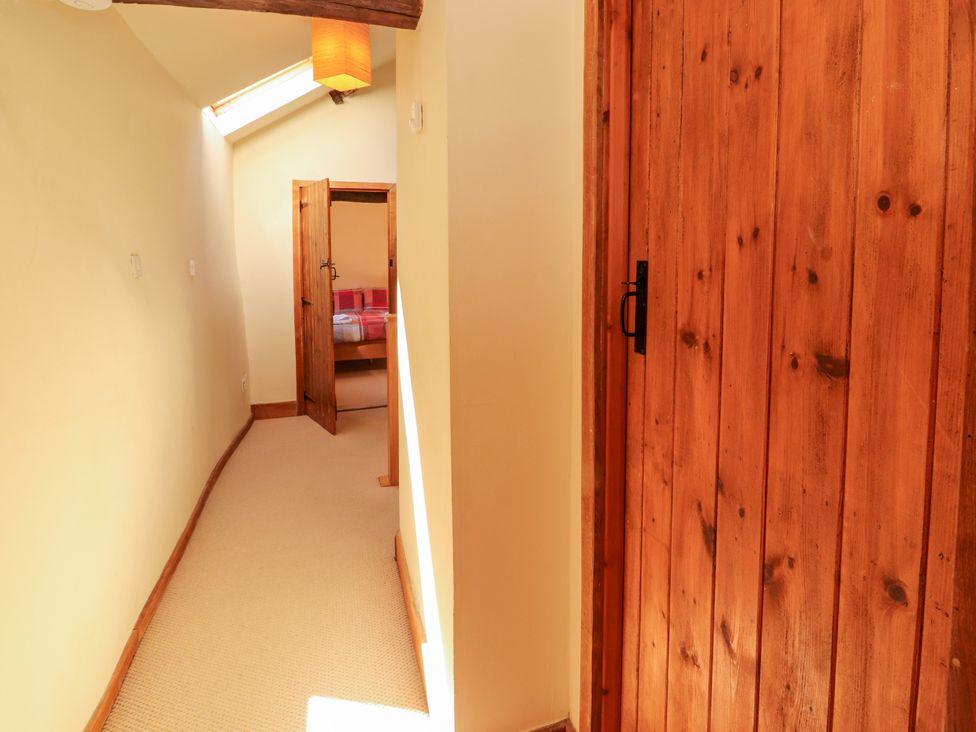 A hallway with doors leading to a bedroom at Beck Edge in Braithwaite