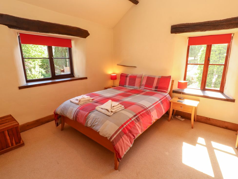 A bedroom with a bed and bedside table at Beck Edge in Braithwaite