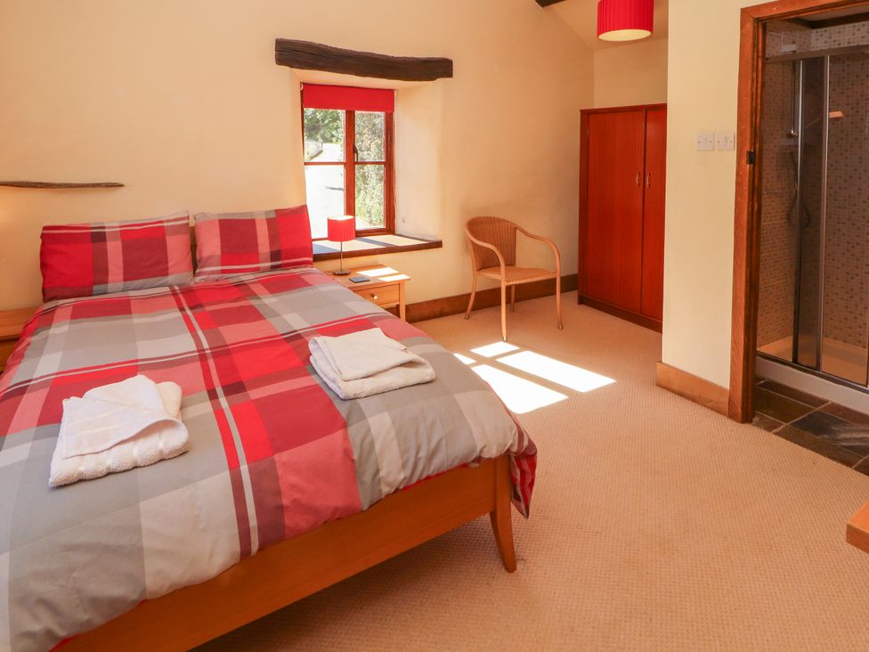 A bedroom with a bed and wardrobe at Beck Edge in Braithwaite