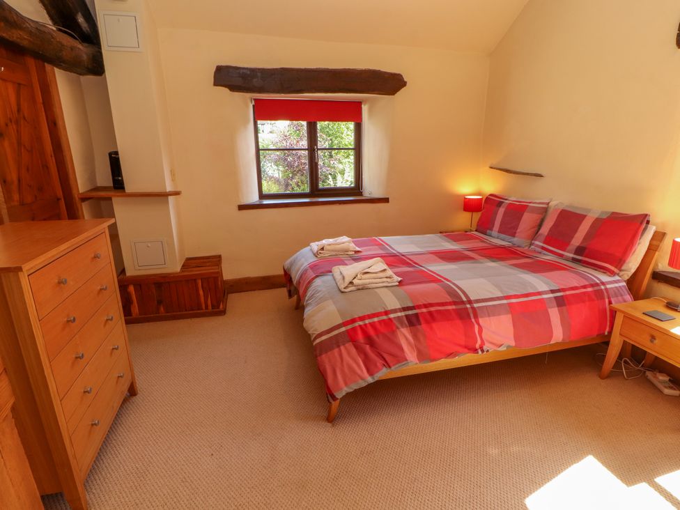A bedroom with a bed and dresser at Beck Edge in Braithwaite