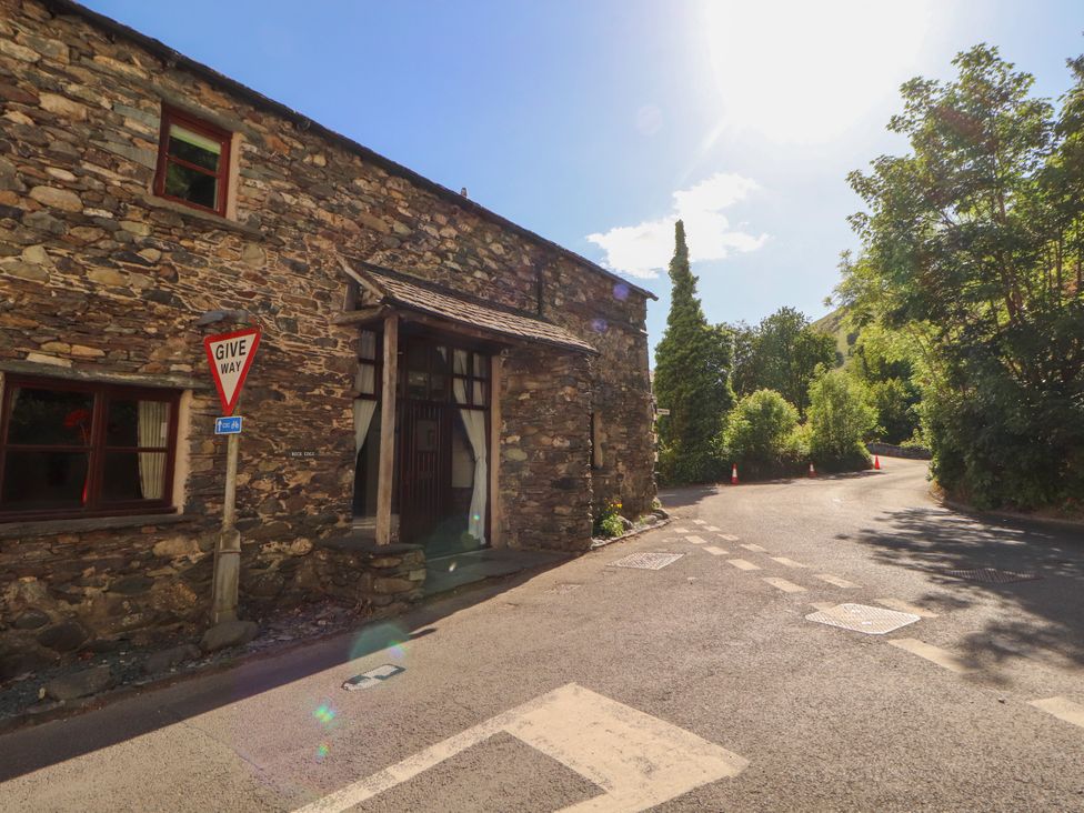 A stone building with a road sign at Beck Edge in Braithwaite
