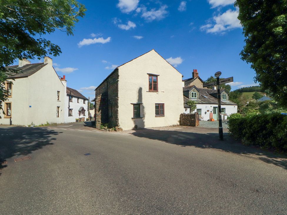 A street view with houses and a road sign at Beck Edge in Braithwaite