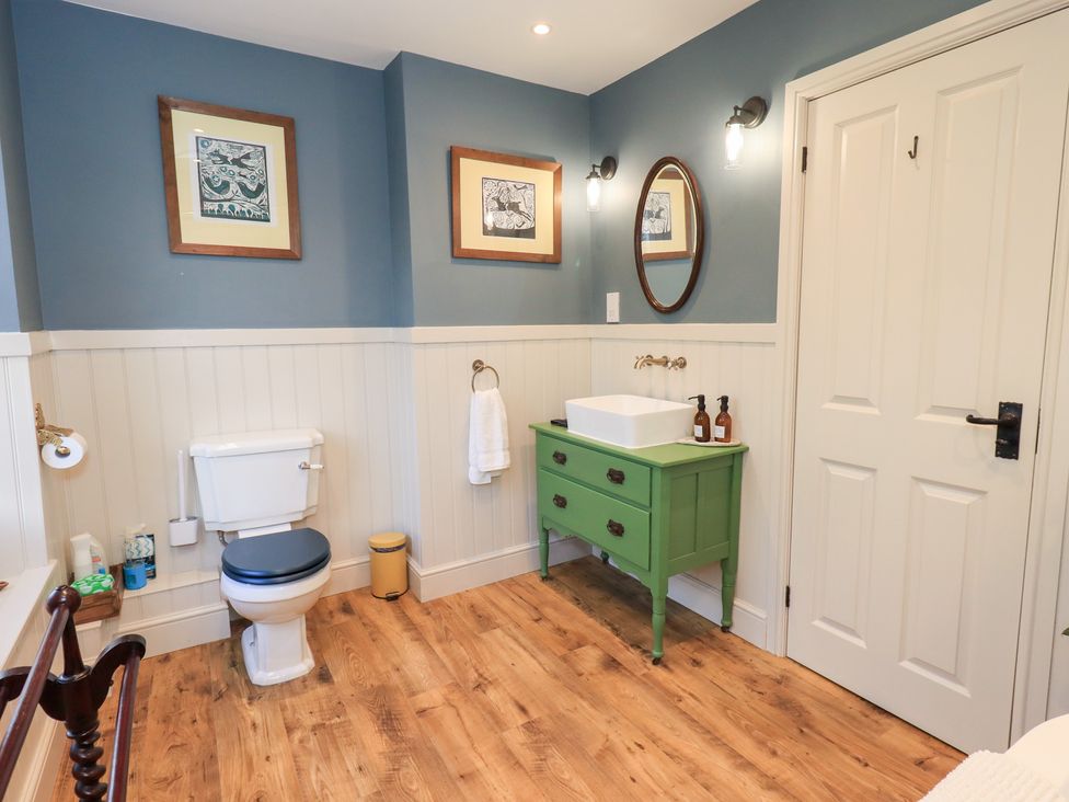 A bathroom with a toilet and wash basin at Gosling Cottage in Kendal