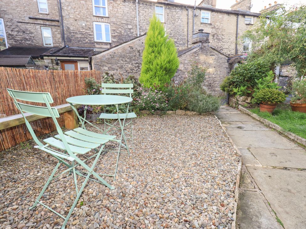 A garden with a table and chairs at Gosling Cottage in Kendal