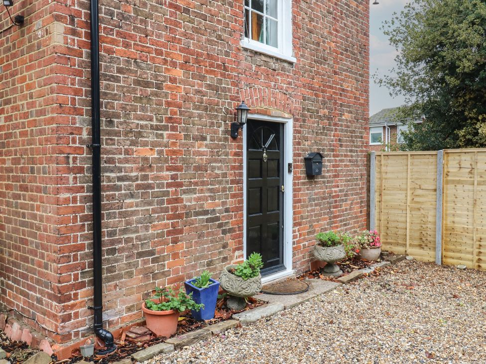 An entrance with a door and flower pots at Chilton Manor House in Sittingbourne