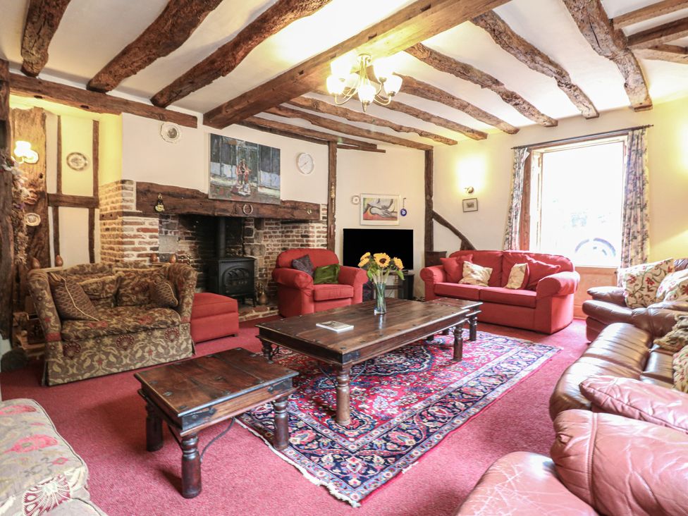 A living room with a fireplace and sofas at Chilton Manor House in Sittingbourne