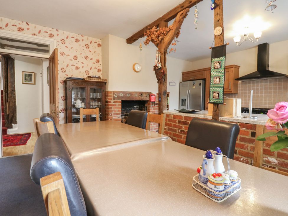 A kitchen with a dining table and chairs at Chilton Manor House in Sittingbourne