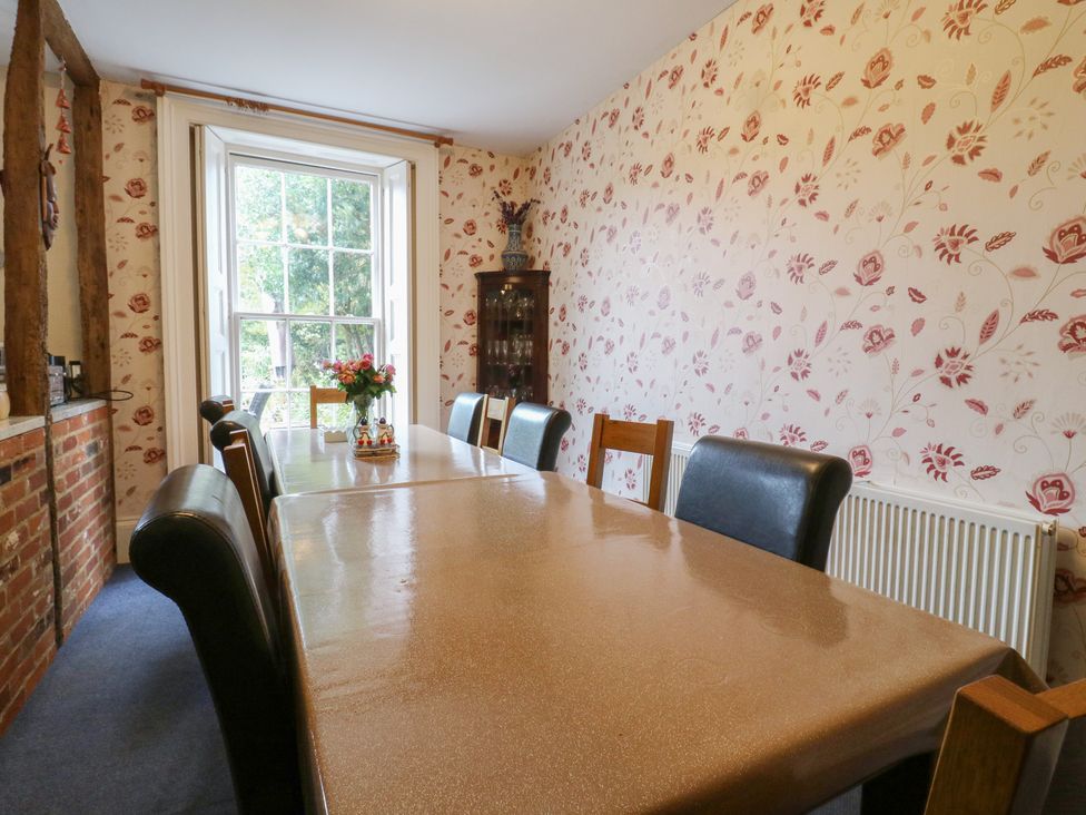 A dining room with a table and chairs at Chilton Manor House Sittingbourne