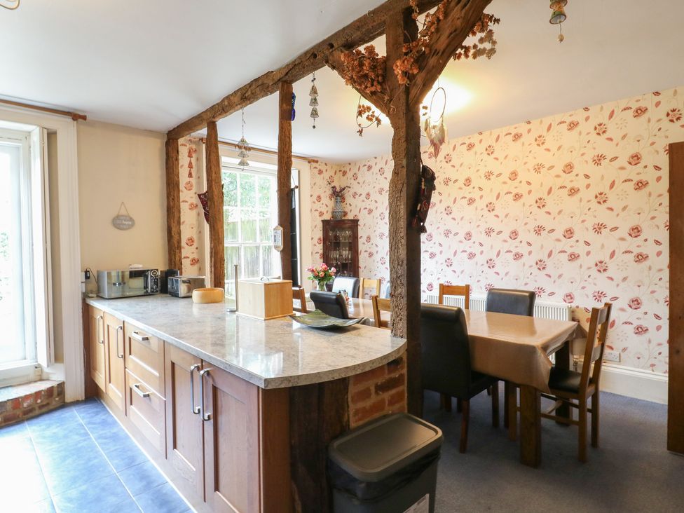A kitchen with a dining table and chairs at Chilton Manor House in Sittingbourne