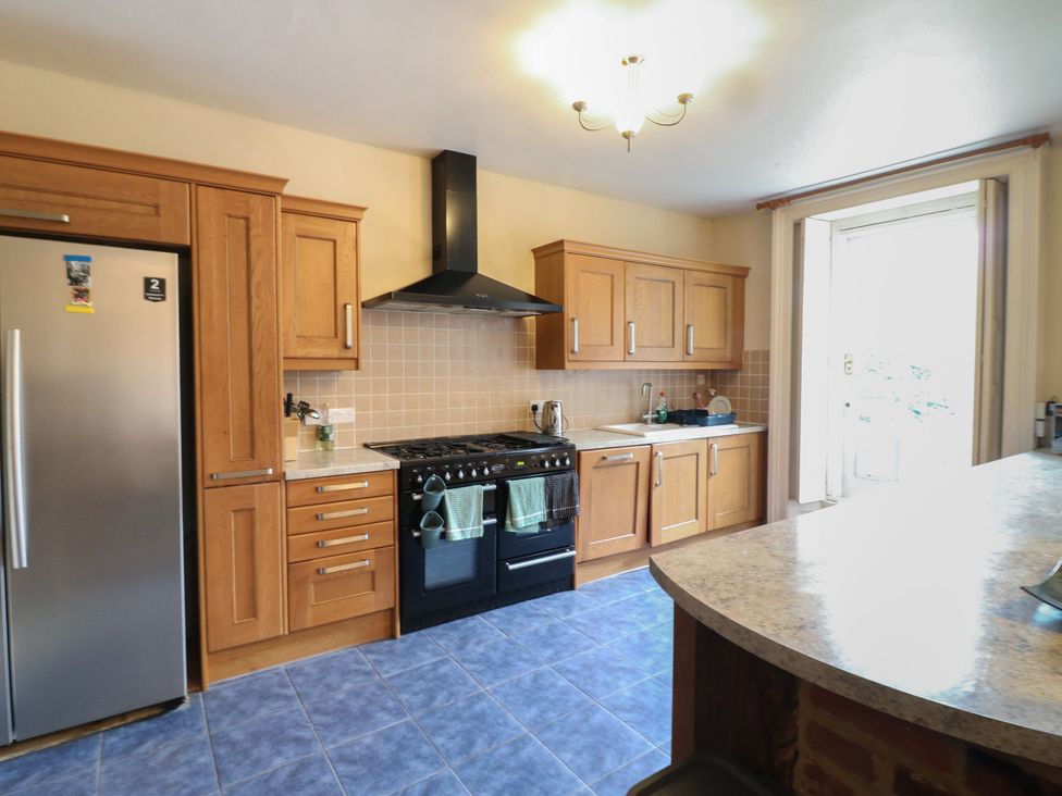 A kitchen with cabinets and appliances at Chilton Manor House in Sittingbourne